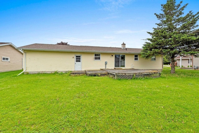 1517 Navarino St, Algoma, WI 54201 - back of property featuring a deck, a lawn, and a chimney
