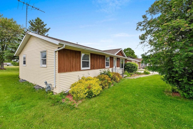 1517 Navarino St, Algoma, WI 54201 - view of side of property with a lawn and board and batten siding