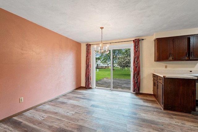 1517 Navarino St, Algoma, WI 54201 - unfurnished dining area featuring a chandelier and light wood-style flooring