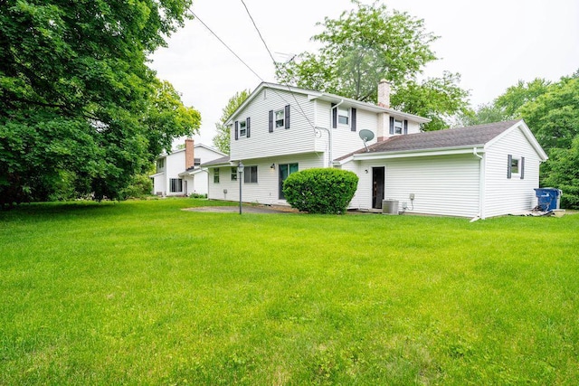 9600 W Debbie Ln, Milwaukee, WI 53224 - back of property featuring a chimney and a lawn