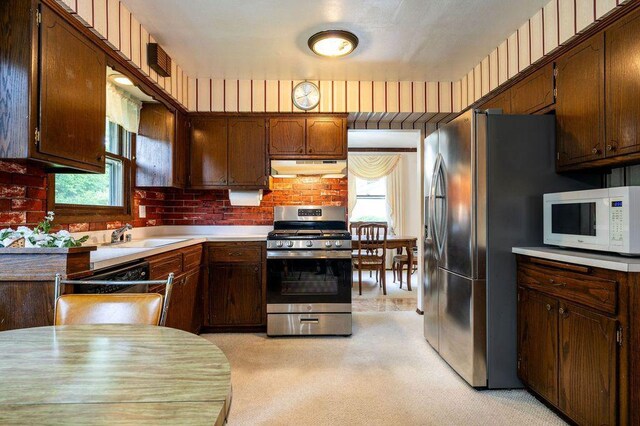 9600 W Debbie Ln, Milwaukee, WI 53224 - kitchen featuring stainless steel appliances, under cabinet range hood, plenty of natural light, and light carpet