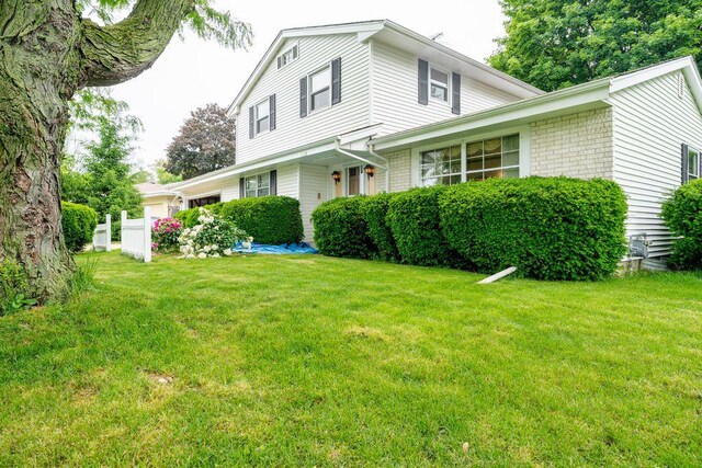 9600 W Debbie Ln, Milwaukee, WI 53224 - view of front facade with a front yard and an attached garage