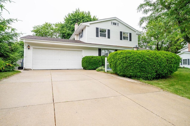 9600 W Debbie Ln, Milwaukee, WI 53224 - view of front facade with an attached garage, driveway, and a chimney