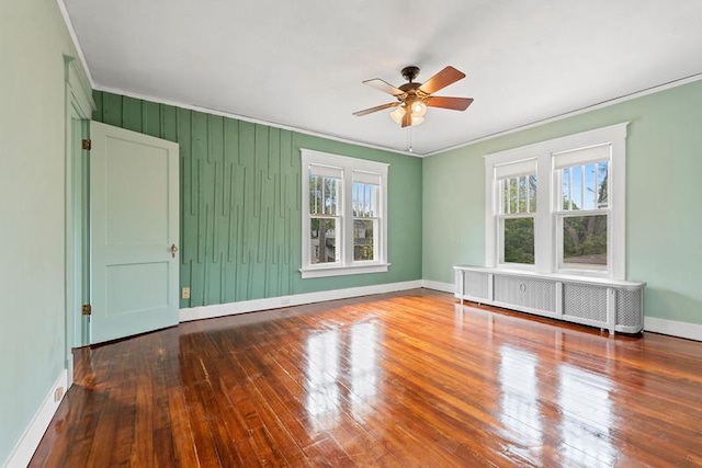 701 N 7th St, Manitowoc, WI 54220 - unfurnished room with healthy amount of natural light, crown molding, a ceiling fan, hardwood / wood-style flooring, and radiator heating unit