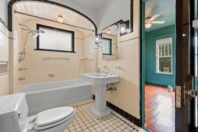 701 N 7th St, Manitowoc, WI 54220 - full bathroom featuring bathtub / shower combination, ceiling fan, tile walls, and tile patterned floors