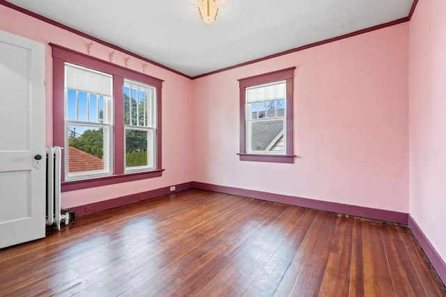 701 N 7th St, Manitowoc, WI 54220 - empty room with plenty of natural light, ornamental molding, hardwood / wood-style flooring, and radiator