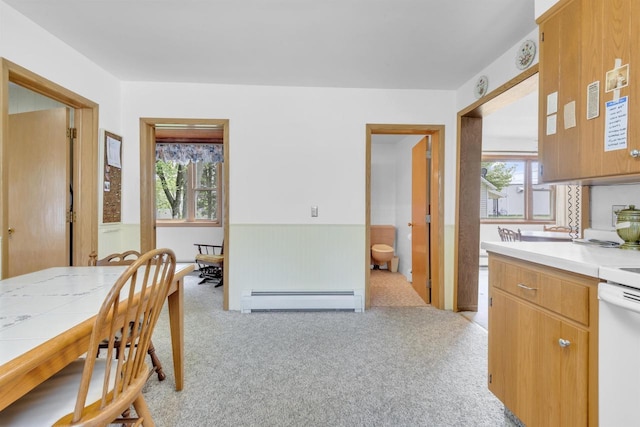 615 Ogden St, Marinette, WI 54143 - dining space with a baseboard radiator, plenty of natural light, light colored carpet, and wainscoting