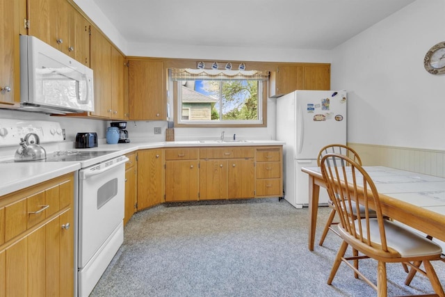 615 Ogden St, Marinette, WI 54143 - kitchen featuring white appliances, light countertops, and brown cabinetry