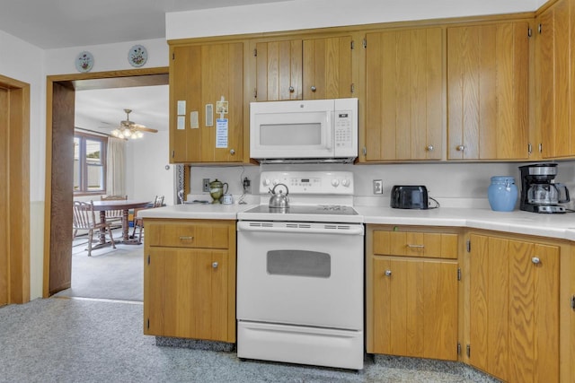 615 Ogden St, Marinette, WI 54143 - kitchen featuring white appliances, light countertops, light carpet, ceiling fan, and brown cabinetry