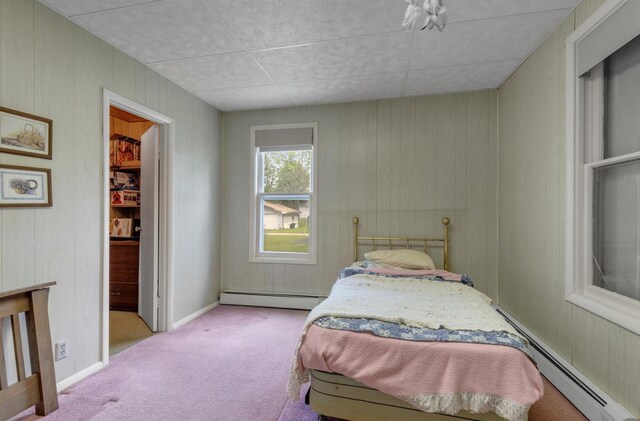 615 Ogden St, Marinette, WI 54143 - carpeted bedroom featuring a baseboard heating unit and wooden walls