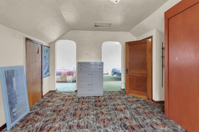 615 Ogden St, Marinette, WI 54143 - hallway featuring lofted ceiling, carpet, attic access, and arched walkways