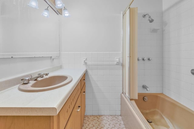 615 Ogden St, Marinette, WI 54143 - full bathroom featuring vanity, tile walls,  shower combination, and tile patterned floors
