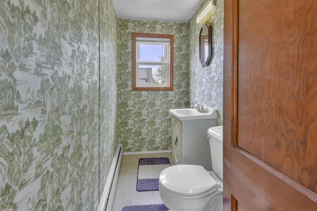 615 Ogden St, Marinette, WI 54143 - bathroom with wallpapered walls, baseboard heating, and vanity