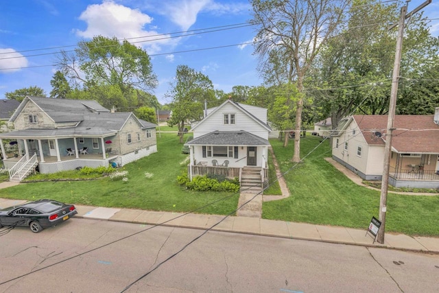 615 Ogden St, Marinette, WI 54143 - view of front facade featuring covered porch and a front yard