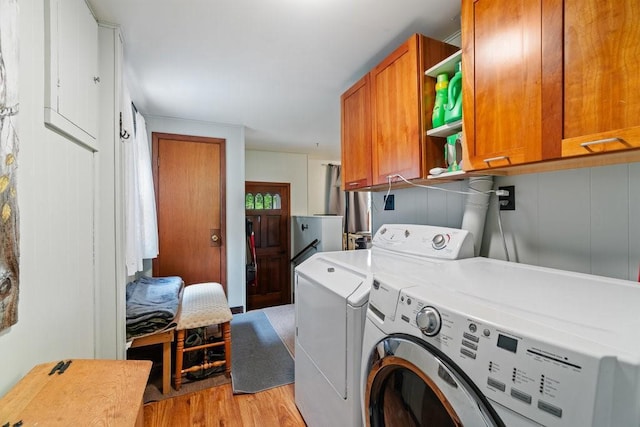 214 E Dell St, New Auburn, WI 54757 - washroom featuring cabinet space, separate washer and dryer, and light wood-style floors