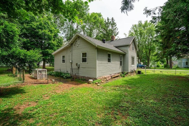 214 E Dell St, New Auburn, WI 54757 - view of home's exterior featuring a yard, a chimney, and roof with shingles