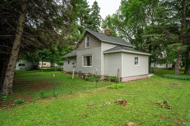 214 E Dell St, New Auburn, WI 54757 - view of property exterior with a chimney, roof with shingles, and a lawn