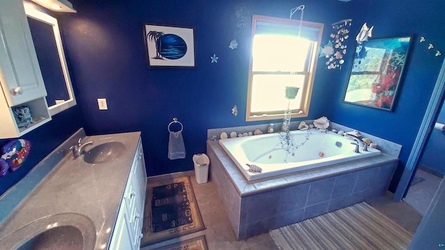 70355 Laine Rd, Iron River, WI 54847 - bathroom featuring double vanity, a whirlpool tub, and tile patterned floors
