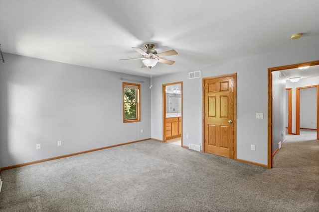 1601 Raspberry Ln, Mount Horeb, WI 53572 - unfurnished bedroom featuring light colored carpet, ensuite bathroom, and a ceiling fan