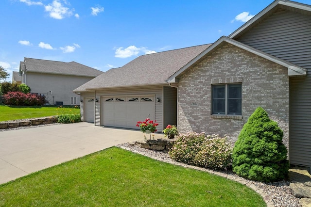 1601 Raspberry Ln, Mount Horeb, WI 53572 - view of front of home with a garage, brick siding, concrete driveway, and a front lawn
