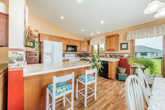 143 Parkview Ct, Cedar Grove, WI 53013 - kitchen featuring black appliances, a peninsula, light wood finished floors, light countertops, and lofted ceiling