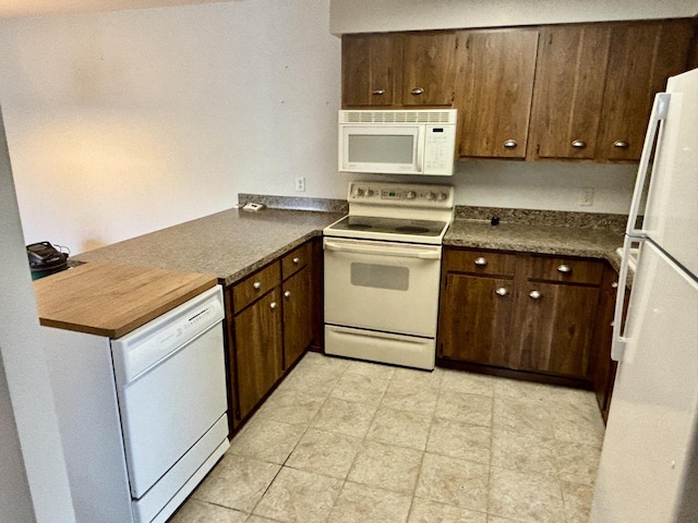 1712 Creek Rd Unit 202, West Bend, WI 53090 - kitchen featuring white appliances, dark countertops, and a peninsula