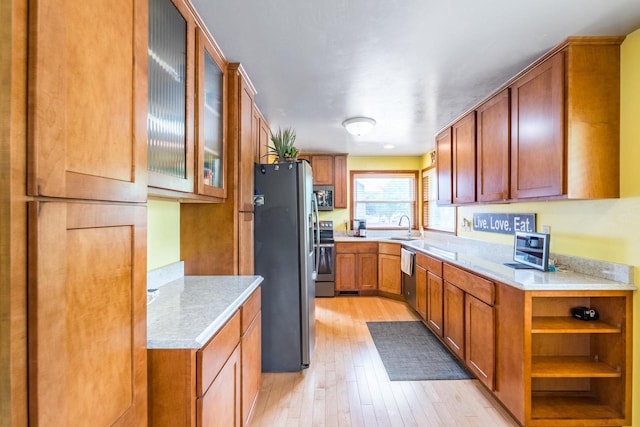1508 Pearson St, Wausau, WI 54401 - kitchen featuring appliances with stainless steel finishes, light wood-style flooring, light countertops, and brown cabinetry