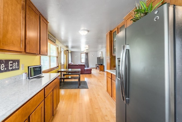 1508 Pearson St, Wausau, WI 54401 - kitchen with stainless steel refrigerator with ice dispenser, light countertops, open floor plan, and light wood finished floors
