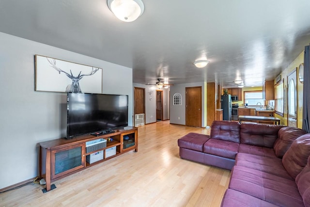 1508 Pearson St, Wausau, WI 54401 - living room featuring light wood finished floors and a ceiling fan