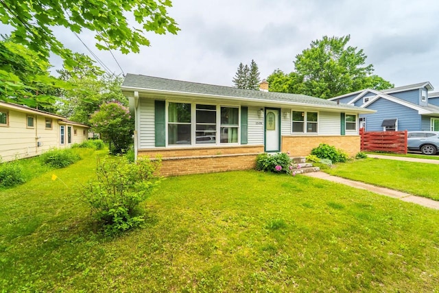 1508 Pearson St, Wausau, WI 54401 - view of front of house featuring brick siding, a chimney, and a front yard