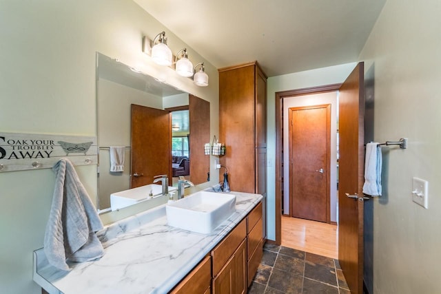 1508 Pearson St, Wausau, WI 54401 - bathroom with vanity and stone finish floors