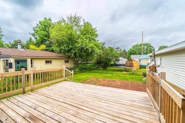 1508 Pearson St, Wausau, WI 54401 - wooden deck featuring a trampoline, a fenced backyard, and a shed