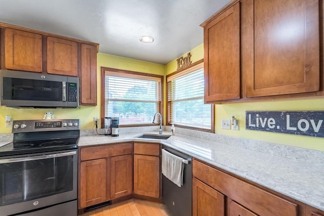 1508 Pearson St, Wausau, WI 54401 - kitchen with stainless steel appliances, brown cabinets, and light stone countertops