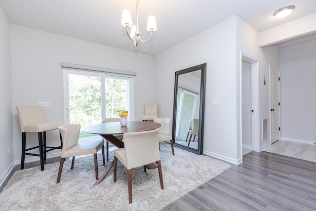 310 Paradise Ct, Hartland, WI 53029 - dining room featuring light wood-style floors and a chandelier