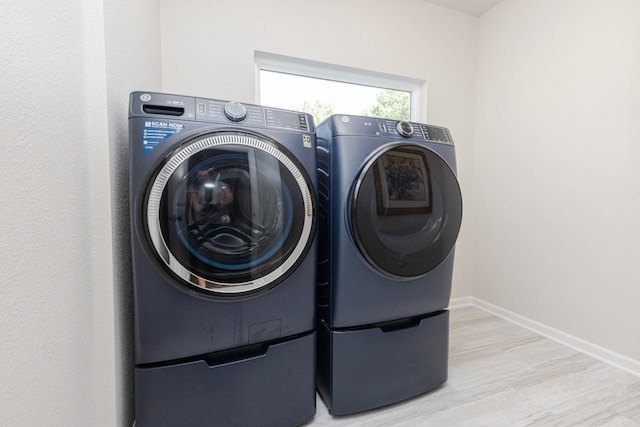 310 Paradise Ct, Hartland, WI 53029 - laundry room featuring separate washer and dryer and wood finished floors