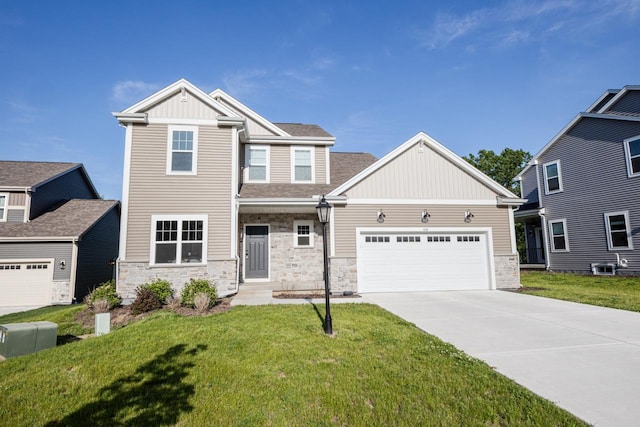 310 Paradise Ct, Hartland, WI 53029 - craftsman-style house with stone siding, an attached garage, driveway, board and batten siding, and a front lawn