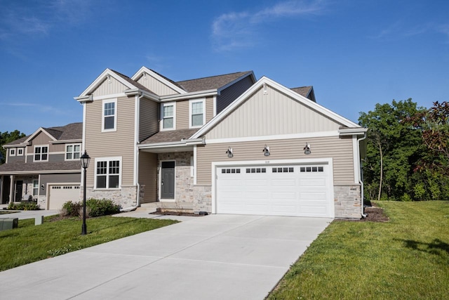 310 Paradise Ct, Hartland, WI 53029 - craftsman house with board and batten siding, stone siding, a front lawn, concrete driveway, and a garage