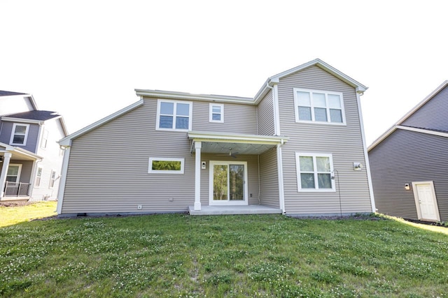 310 Paradise Ct, Hartland, WI 53029 - back of property featuring a lawn and a patio area