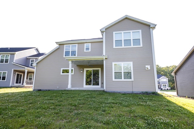 310 Paradise Ct, Hartland, WI 53029 - rear view of house featuring a lawn