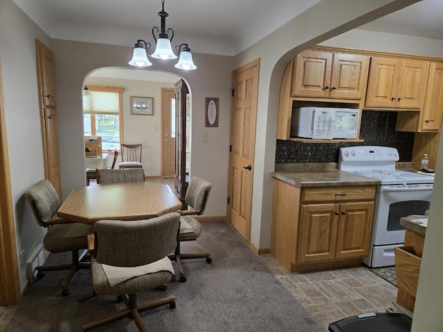 131 Crestview Ln, Nekoosa, WI 54457 - kitchen featuring white appliances, arched walkways, backsplash, a chandelier, and decorative light fixtures