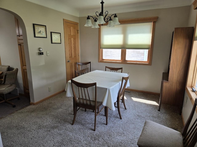 131 Crestview Ln, Nekoosa, WI 54457 - dining room featuring a chandelier, arched walkways, and light carpet