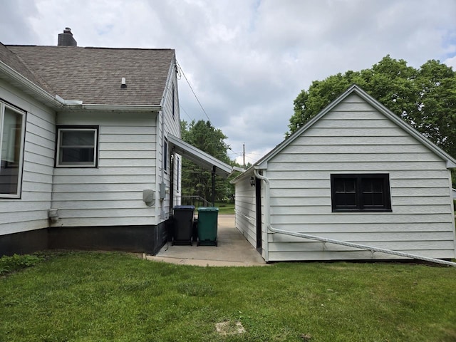 131 Crestview Ln, Nekoosa, WI 54457 - view of side of home with a lawn, a chimney, and a shingled roof