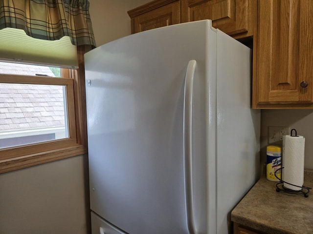 131 Crestview Ln, Nekoosa, WI 54457 - kitchen with freestanding refrigerator and brown cabinets