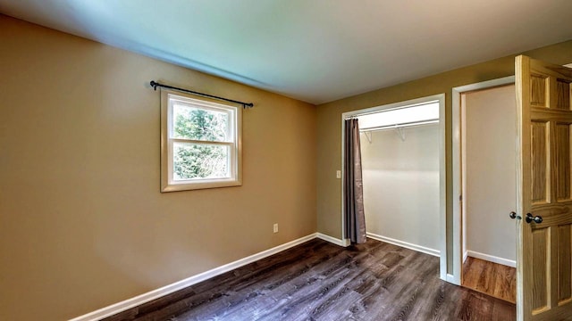N2493 Kunz Rd, Fort Atkinson, WI 53538 - unfurnished bedroom featuring dark wood-type flooring and a closet
