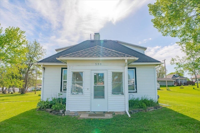 500 2nd Ave, Hollandale, WI 53544 - rear view of house featuring a lawn, a chimney, and a shingled roof