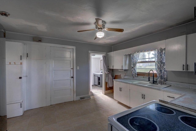 500 2nd Ave, Hollandale, WI 53544 - kitchen featuring range, light countertops, ceiling fan, white cabinetry, and light tile patterned flooring