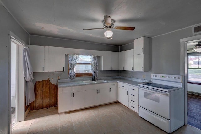 500 2nd Ave, Hollandale, WI 53544 - kitchen featuring white electric stove, ceiling fan, light countertops, and white cabinets