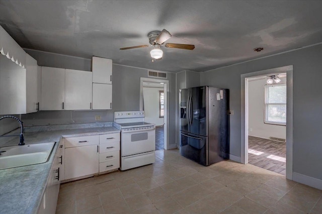 500 2nd Ave, Hollandale, WI 53544 - kitchen with black refrigerator with ice dispenser, white range with electric cooktop, ceiling fan, white cabinetry, and light countertops