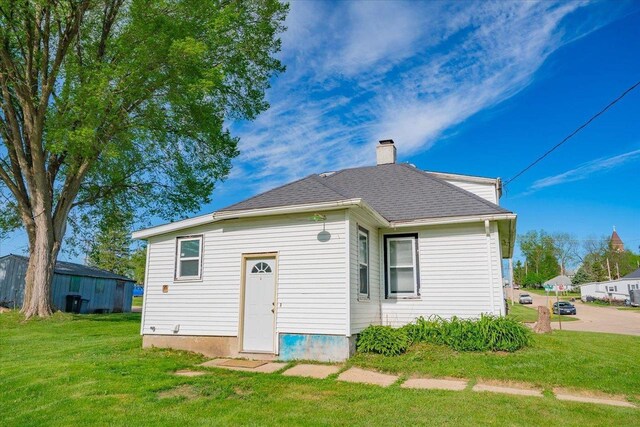 500 2nd Ave, Hollandale, WI 53544 - rear view of property featuring a lawn and a chimney
