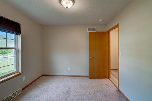 862 Stonefield Dr, Edgerton, WI 53534 - unfurnished room with plenty of natural light, light colored carpet, and a smoke detector